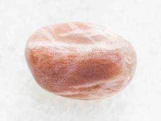 tumbled moonstone gemstone on white marble