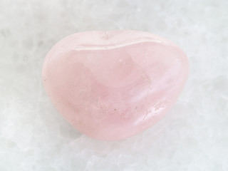 polished Rose Quartz gem stone on white marble