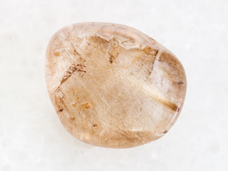 Rutilated Quartz gemstone on white marble