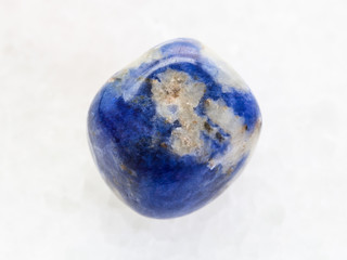 polished Sodalite gemstone on white marble