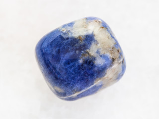 tumbled Sodalite gemstone on white marble