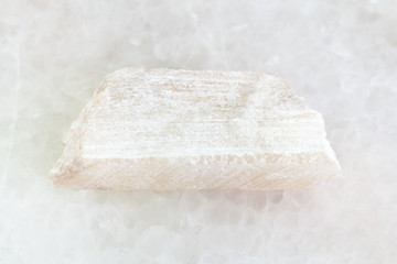 raw Talc stone on white marble