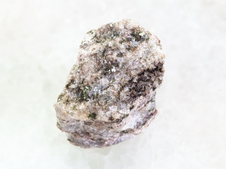 rough Apatite stone on white marble