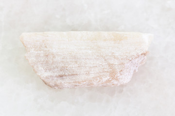 rough Talc stone on white marble