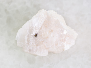 raw Barite stone on white marble