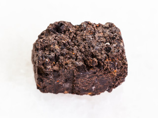 raw Peat Turf stone on white marble