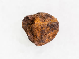 rough limonite (iron ore) stone on white marble