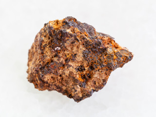 raw Hematite (iron ore) stone on white marble