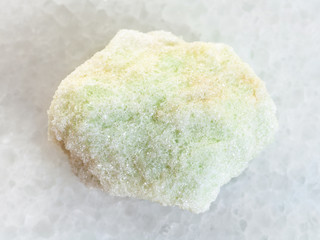 rough Lavrovite stone on white marble