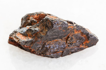 rough Wolframite stone (tungsten ore) on white
