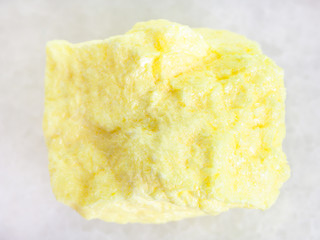 raw native Sulphur stone on white marble