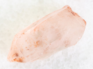 rough crystal of rose quartz gemstone on white