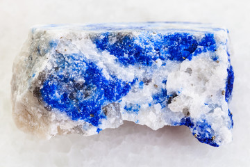 raw lapis lazuli stone on white marble