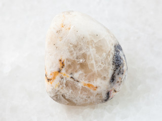 tumbled baryte stone on white marble