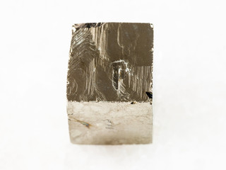 rough pyrite crystal on white marble