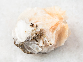 raw Thomsonite stone on white marble
