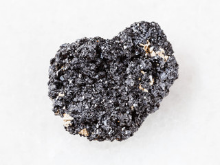 crystalline Perovskite stone on white marble