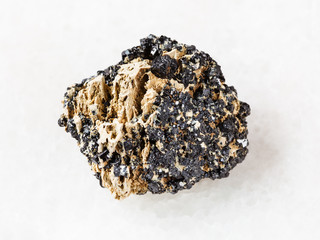 piece of Perovskite stone on white marble