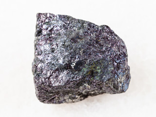 piece of bornite stone on white marble