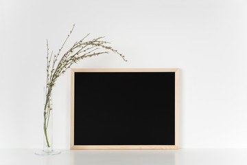 lletter board on a wood background with spring floers. Horizontal