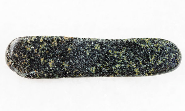 polished tholeiite basalt stone on white marble