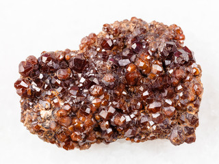 raw Andradite garnet crystals on stone on white