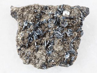 magnetite crystals on raw stone on white marble