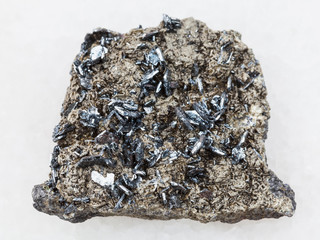 magnetite crystals on rough stone on white