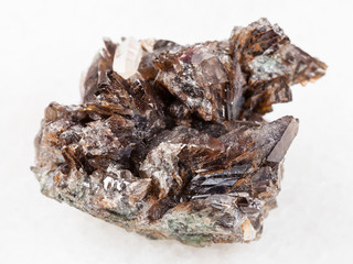 rough crystals of axinite stone on white