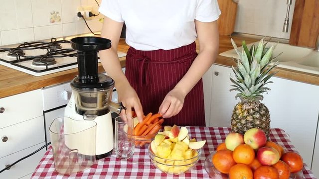 woman prepares fresh fruit juice