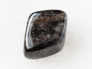 tumbled anthophyllite gemstone on white