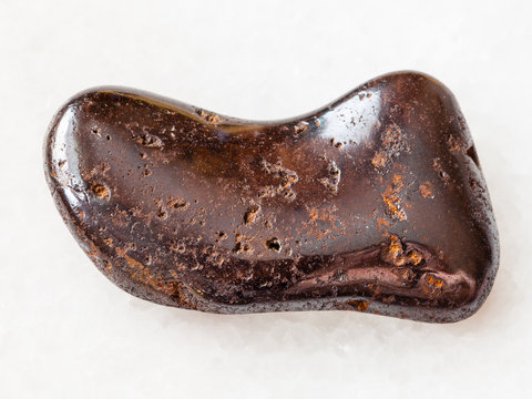polished hydrogoethite gemstone on white