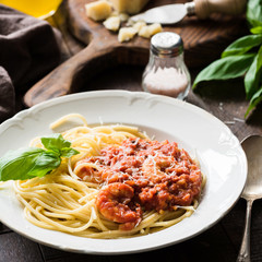 Italian pasta with tomato sauce and shrimps on white plate, cloeup view, square crop