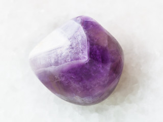polished amethyst gem stone on white