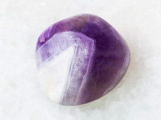 tumbled amethyst gem stone on white © vvoe