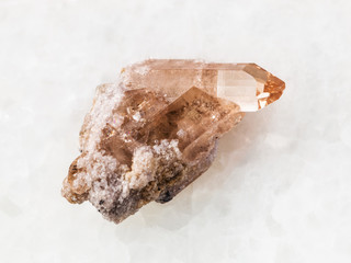 raw crystal of topaz gemstone on white