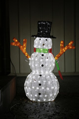 Night view of the illuminations of the snowman put in the entrance hall of the house