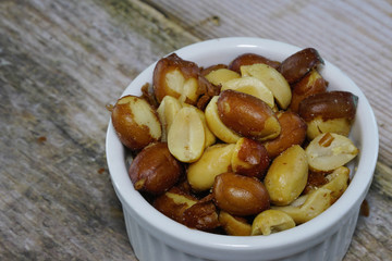 peanuts fresh  in a white bowl on the table