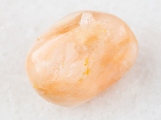 tumbled Stilbite gemstone on white