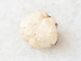 rough analcime gemstone on white
