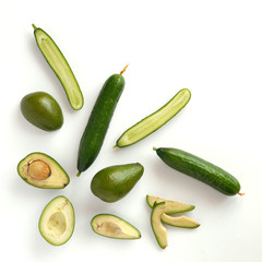 Cucumber, avocado, apple isolated on white background, top view, flat layout. Composition of various vegetables and fruits with copy space.