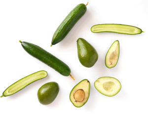 Cucumber, avocado, apple isolated on white background, top view, flat layout. Composition of various vegetables and fruits with copy space.