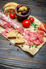 Dried organic salami sausage on wooden background