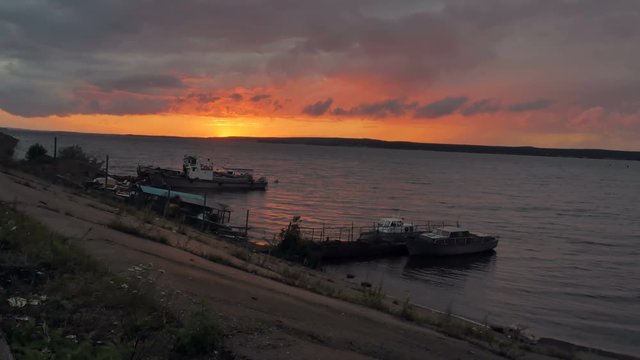 Beautiful sunset on the river. Boats, ships near the river