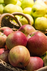 Red and yellow apples in basket. Closeup of red and yellow apples in wicker basket.