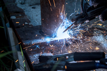 Young man mechanic worker repairing