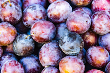 Pile of plum, closeup. Fresh sweet plum in local market.