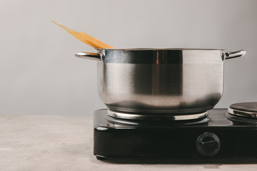 close-up shot of spaghetti boiling in stewpot on concrete tabletop