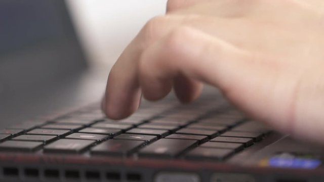 Fingers typing on the laptop