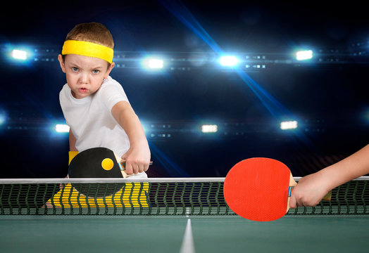 Two boys play ping-pong.
